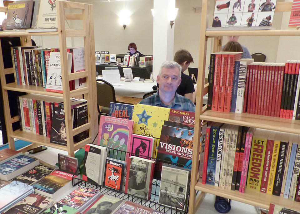 Craig O'Hara of PM Press, who recently moved to Frostburg, displays his press' books during the FSU Independent Literature Festival.