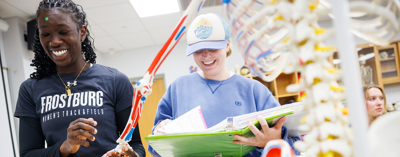 students laughing in class as they discuss the anatomy task