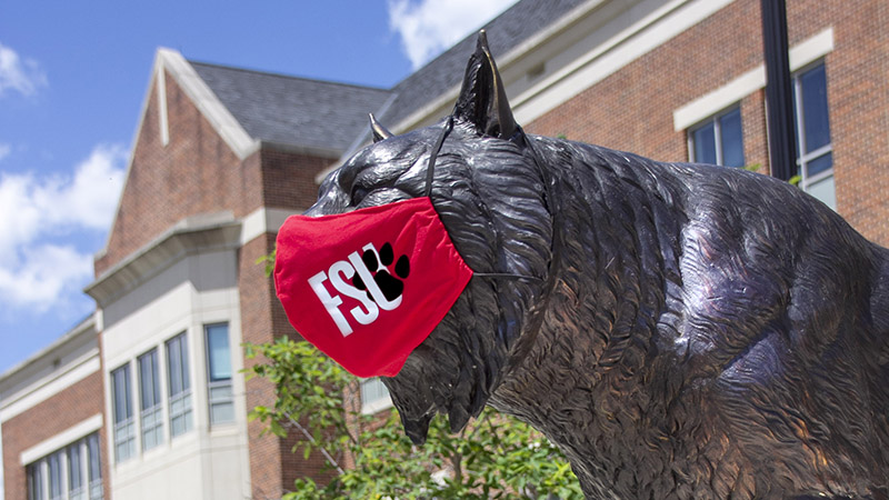 bobcat statue in covid mask