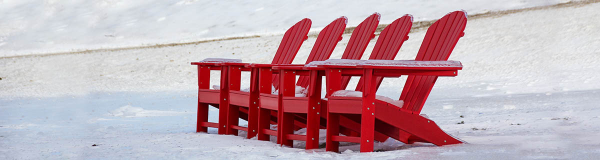 red adirondack chairs covered in snow