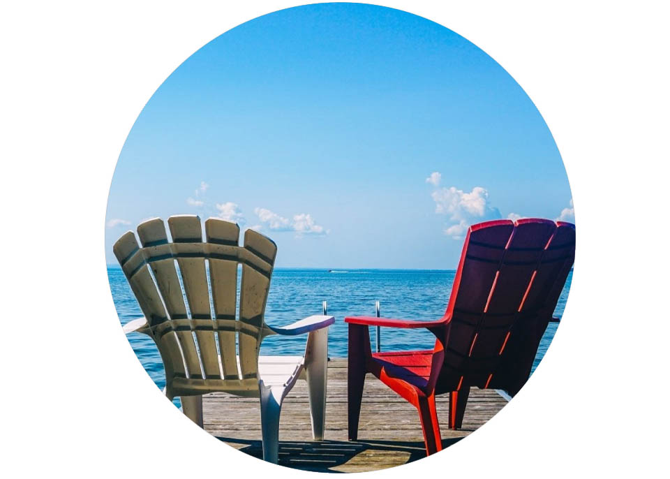 deck chairs on a dock facing water