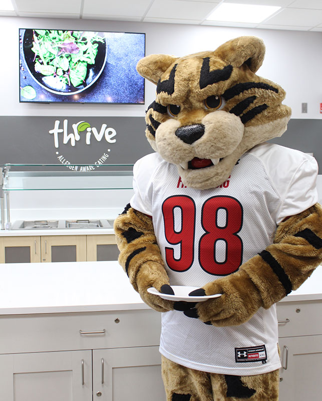 Frostburg Bobcat holding a plate at Bobcat Dining