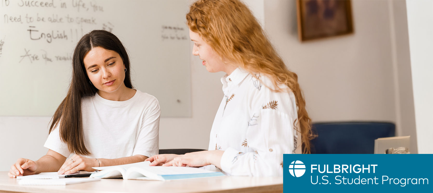 Student conversing and teaching English