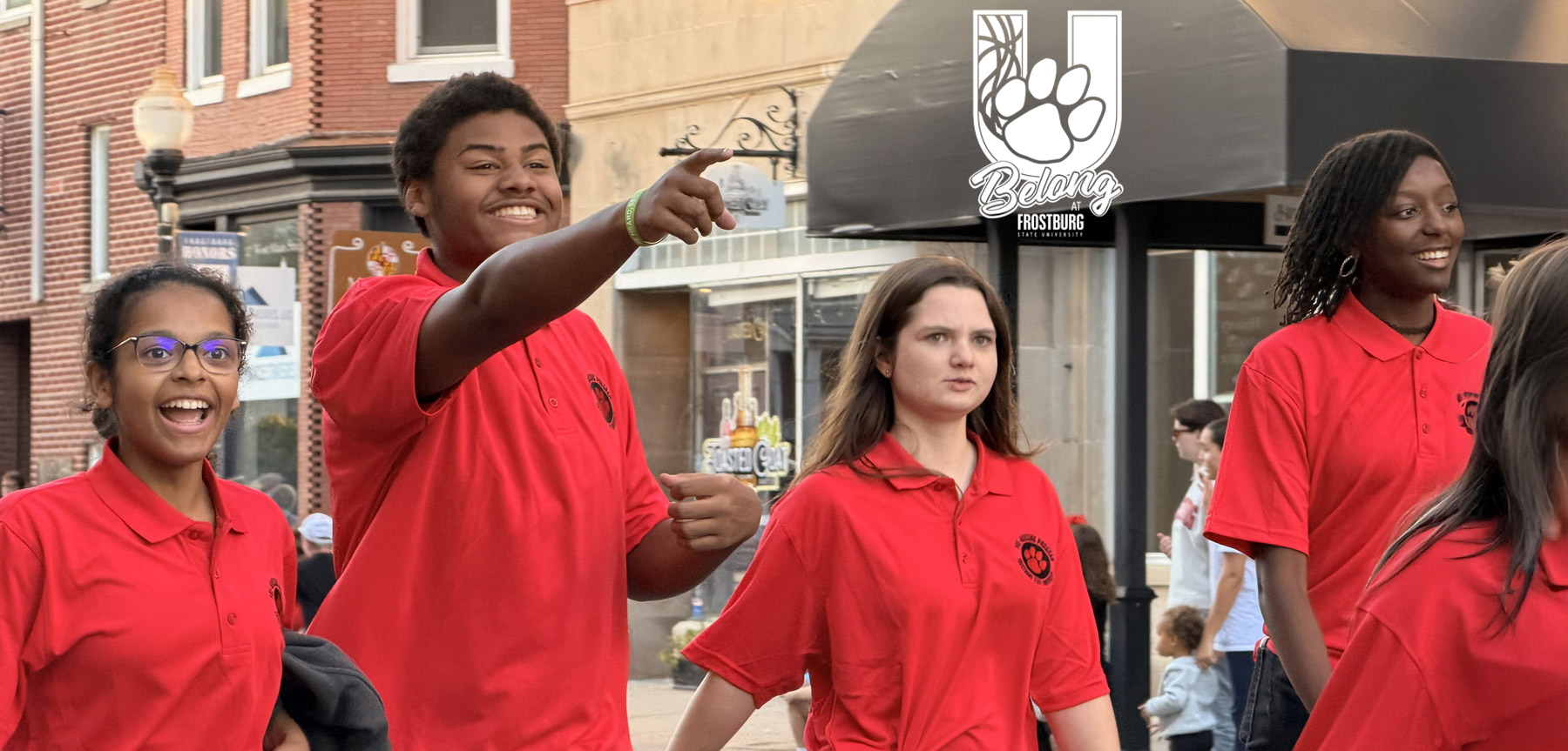 Students interacting with crowd in the Frostburg Homecoming parade